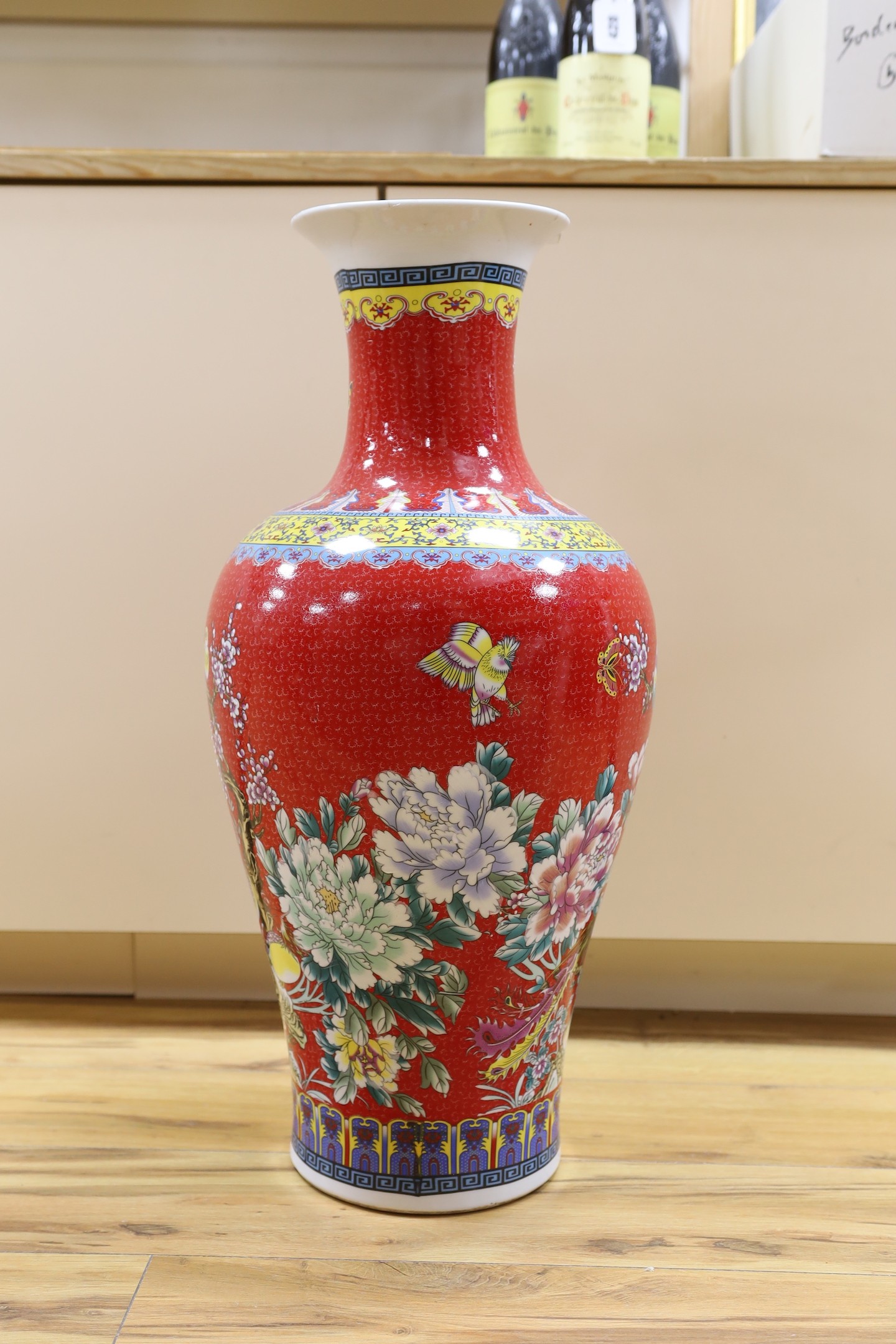 A large modern red ground Chinese vase with floral decoration - 68.5cm tall
